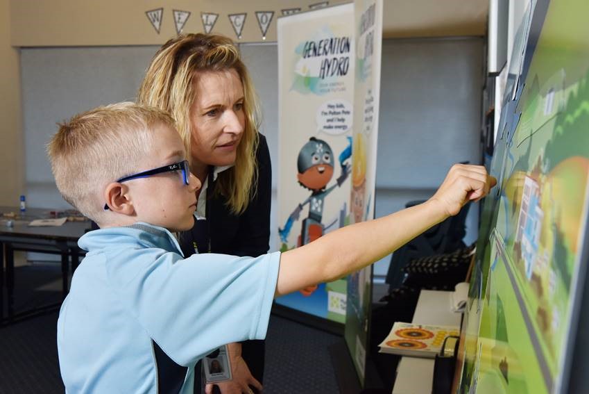 Education coordinator, Gina Harvey, showing a student a diagram of water flow