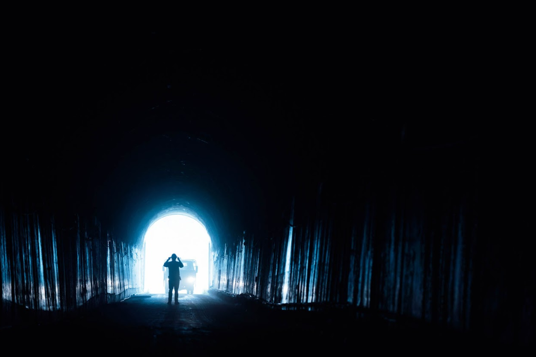 Person walking up tunnel from underground power station