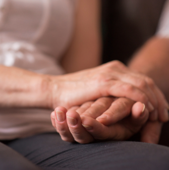 Two people holding hands